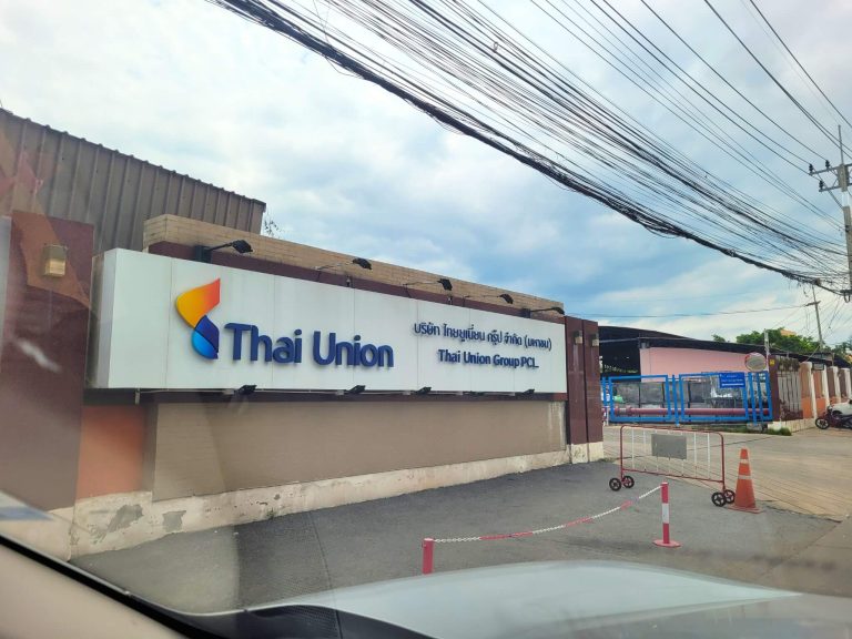 HydroNeo team on their way to the entrance of Thai Union Group PCL (Thailand), featuring its company sign and security barriers